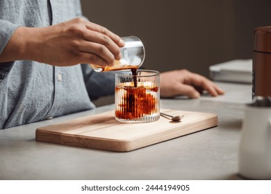 Barista Crafting Iced Espresso With Mineral Water at Counter - Powered by Shutterstock