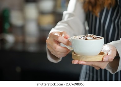 Barista Hand Holding A Cup Of Hot Coffee To Serving Customer                              