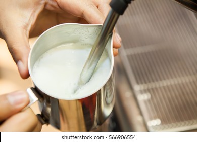 barista make a cappuccino or latte steaming and frothing milk - Powered by Shutterstock