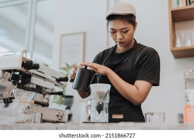 Barista making coffee by pour over in coffee shop. Close up of hands barista to making a drip coffee. Coffee shop concept