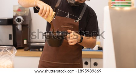 Barista making coffee in coffeeshop