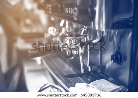 Barista making coffee grinding freshly roasted coffee beans in cafe