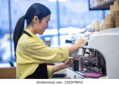 Barista Making Coffee And Stirring Milk