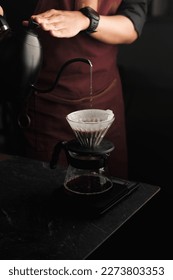 Barista is making drip brewing, filtered coffee, or pour over coffee with hot water and filter paper in coffee shop.vintage tone. - Shutterstock ID 2273803353