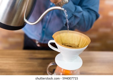 Barista making a drip coffee