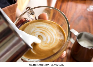 Barista Making Latte Art In Coffee Cup