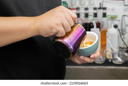 Barista Pouring Latte Art In A Coffee Mug.