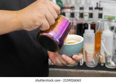 Barista Pouring Latte Art In A Coffee Mug.