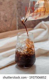 Barista Pouring Milk Into A Glass Of Iced Coffee