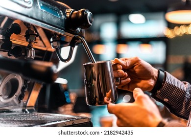 Photo of Barista pouring milk for prepare cup of coffee. Latte art. Morning cup of coffee in café. Brewing coffee. Coffee shop concept. Vertical photo