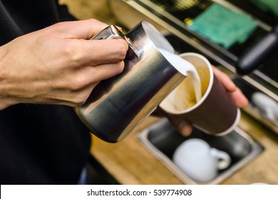 Barista Pouring Milk To Takeaway Coffee. Close-up View On Hands, Small Coffee Business Concept.