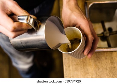 Barista Pouring Milk To Takeaway Coffee. Close-up View On Hands, Small Coffee Business Concept.