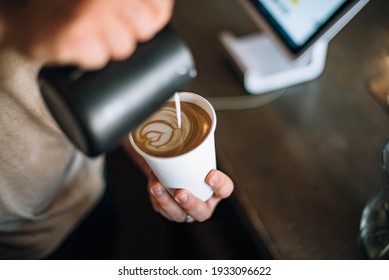 Barista Preparing Takeaway Latte in Coffee Shop - Powered by Shutterstock