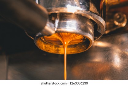 Barista Pulling An Espresso Shot With Crema Pouring Out Of Espresso Machine Group Head