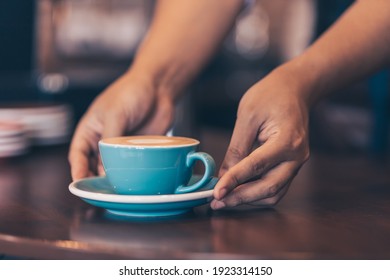 Barista serving a coffee to customer at the coffee shop. - Powered by Shutterstock