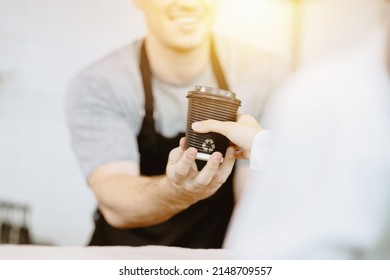 Barista Serving Hot Beverage  To Customer With Recycle Paper Cup