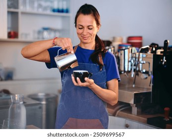 A barista skillfully pours steamed milk into a cup at a cozy coffee shop in the afternoon - Powered by Shutterstock