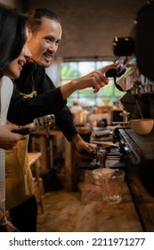 Barista Training Staff Using Coffee Matchine In Coffee Shop Cafe