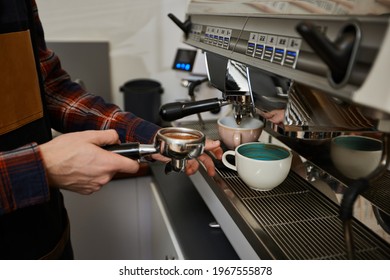 Barista using a coffee machine to make coffee
