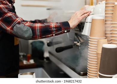 Barista using a coffee machine to make coffee
