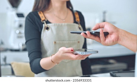 Barista using phone and easy payment in the coffee shop. - Powered by Shutterstock