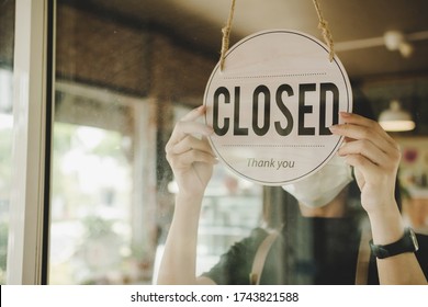 barista, waitress woman wearing protection face mask turning close sign board on glass door in modern cafe coffee shop, cafe restaurant, retail store, small business owner, food and drink concept - Shutterstock ID 1743821588