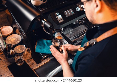 Barista working behind the counter in the cafe, getting ready to make coffee. - Powered by Shutterstock