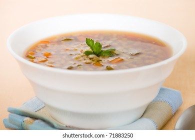 Barley Beef Soup In A White Bowl With A Spoon On The Side. Very Shallow Depth Of Field.