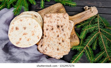 Barley Flatbread Original Lapland Bread On The Wood Cutting Board. Finns Call This Bread Name Rieska. Traditional Food From North