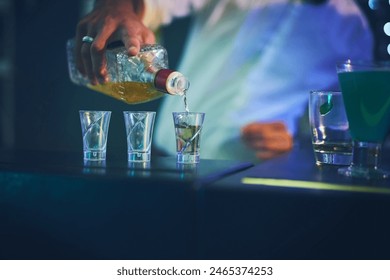 Barman, bottle and pour in shot glasses at night club for service, order and counter server with hospitality. Bartender, employee and hand with prepare spirits in glass at social event and happy hour - Powered by Shutterstock