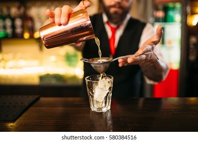 Barman Flaring Behind Bar Counter