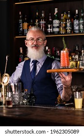 Barman Gray-haired Man With A Beard At Work, Preparing Cocktails, Senor Bartender With Serving Bloody Mary Cocktail, Concept About Service And Beverages.