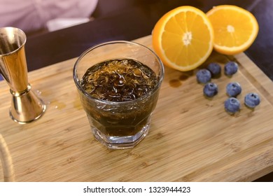 Barman Mixes Alcohol Cocktail On The Rocks. Hands Close-up.