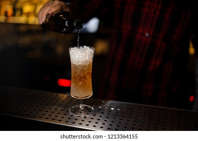 Barman Pouring Fresh Tasty Sherry Cobbler Drink Into A Cocktail Glass On The Bar Counter