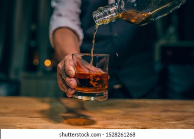 Barman pouring whiskey whiskey glass beautiful night