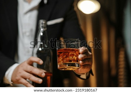 Barman pouring whiskey whiskey glass celebrate whiskey on a friendly party in  restaurant