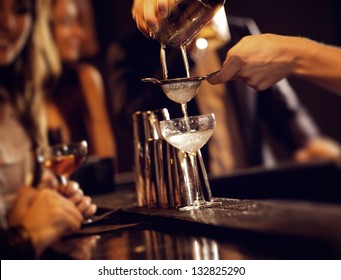 Barman pouring wine from shaker and serving it - Powered by Shutterstock
