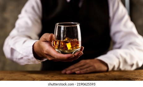 Barman Pouring Wiskey Whiskey Glass And Giving.