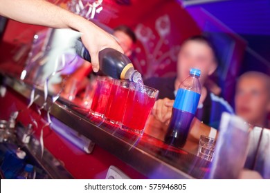 Barman prepares cocktail at the night club.