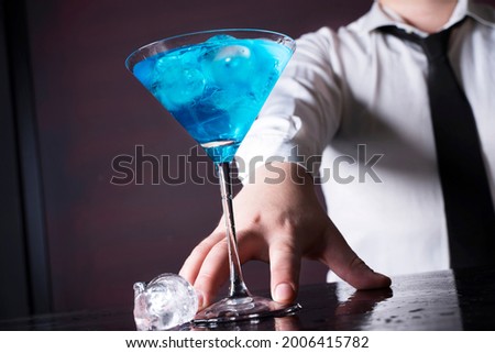 Barman preparing cocktail at the bar counter.Alcoholic drink at the night club