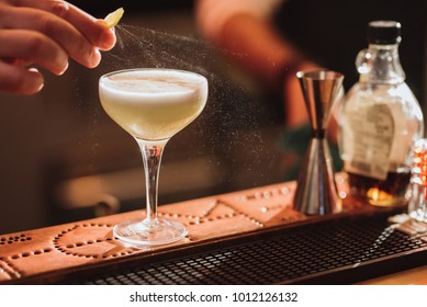 Barman Preparing A Cocktail With A Lemon Spray