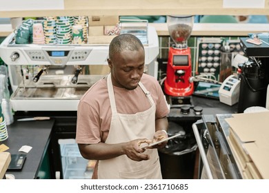 Barman using tablet pc at his work