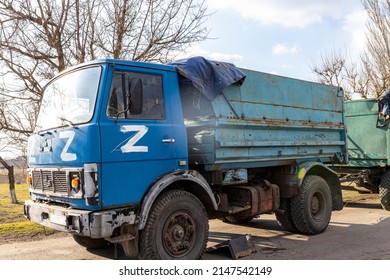 Barmashovo, Ukraine - March 18, 2022: War Of Russia Against Ukraine. Concept Of Invasion. Stolen Ukrainian KAMAZ Truck In The Village With Z Fascist  Russian Symbol Left After Invasion Battle With ZSU