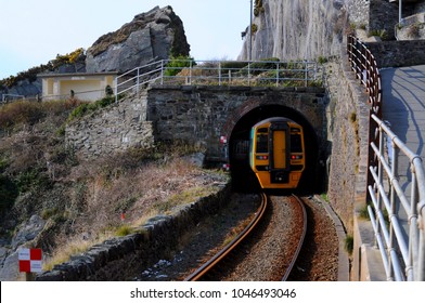 Barmouth, Gwynedd, North Wales / UK - 02/28/2018: Cambrian Line British Rail Class 158 Diesel Multiple Unit (DMU) Passing Under Porkington Terrace.