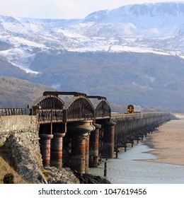 Barmouth, Gwynedd, North Wales / UK - 02/28/2018: Cambrian Line British Rail Class 158 Diesel Multiple Unit (DMU) On Barmouth Viaduct.