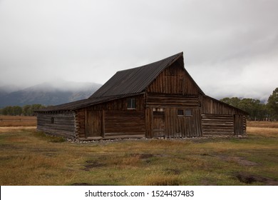 Barn with cloud draped in the background