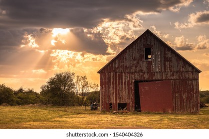 Barn with clouds and sun shining