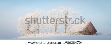 Barn in cold winter landscape