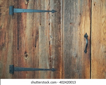 A Barn Door With Black Holders 