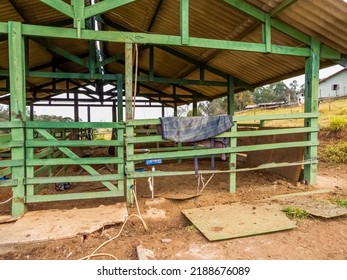 Barn At A Farm. Green Gate With Saddle Pad Hanging On It. 